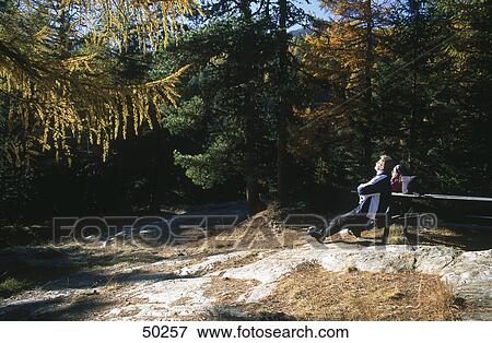 Tourist resting on bench in forest, Eschtal valley, Alto Adige, Italy View Large Photo Image Stock Photo - Tourist resting on bench in forest, Eschtal valley, Alto Adige, Italy . Fotosearch