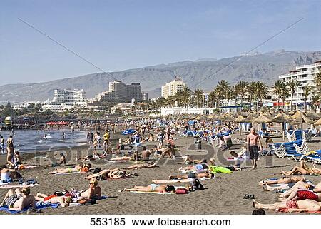 Stock Photography - Tourists enjoying on beach, Playa De Las Americas, Tenerife, Canary Islands, Spain . Fotosearch