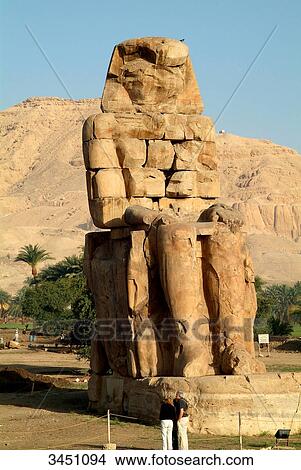 Tourists in front of a Colossus of Memnon, Luxor, Egypt View Large Photo Image Picture - Tourists in front of a Colossus of Memnon, Luxor, Egypt . Fotosearch