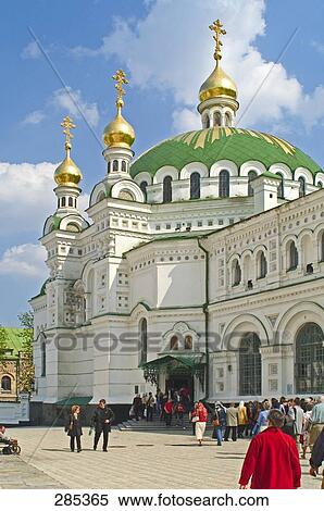 Stock Photography - Tourists in front of monastery, The Refectory church of St. Anthony and Theodosius, Ukraine . Fotosearch