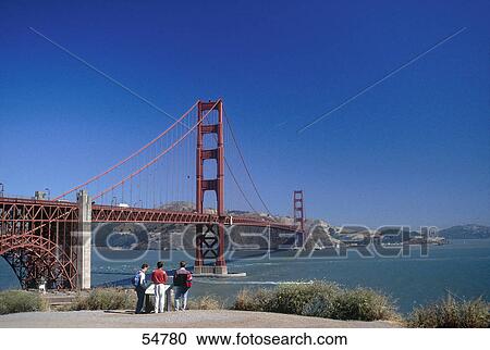 Tourists looking at suspension bridge across bay, Golden Gate Bridge, San Francisco, San Francisco, California, USA View Large Photo Image Stock Image - Tourists looking at suspension bridge across bay, Golden Gate Bridge, San Francisco, San Francisco, California, USA . Fotosearch