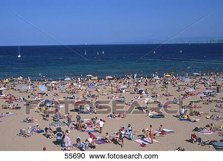 Stock Image - Tourists on beach, Luanco, Asturias, Spain . Fotosearch