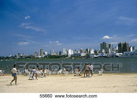 Stock Image - Tourists on beach, Paraguay River, Asuncion, Paraguay . Fotosearch