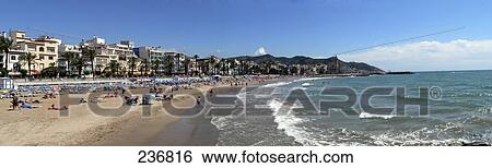 Stock Photograph - Tourists on beach, Sitges, Costa Brava, Catalonia, Spain . Fotosearch