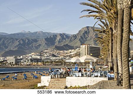 Stock Photograph - Tourists on beach with mountain in background, Pico Del Teide, Tenerife, Canary Islands, Spain . Fotosearch