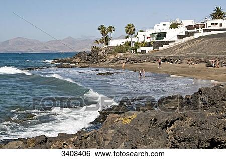 Tourists on the beach of Puerto del Carmen, Lanzarote, Spain, elevated view View Large Photo Image Stock Photograph - Tourists on the beach of Puerto del Carmen, Lanzarote, Spain, elevated view . Fotosearch