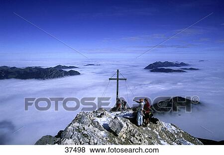 Stock Photo - Tourists on top of mountain, Wetterstein, Bavaria, Germany . Fotosearch