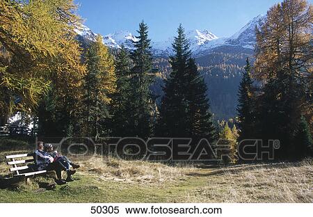 Tourists resting on bench, Alto Adige, Italy View Large Photo Image Stock Photography - Tourists resting on bench, Alto Adige, Italy . Fotosearch