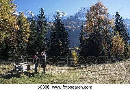 Tourists standing near bench, Alto Adige, Italy View Large Photo Image Stock Photograph - Tourists standing near bench, Alto Adige, Italy . Fotosearch