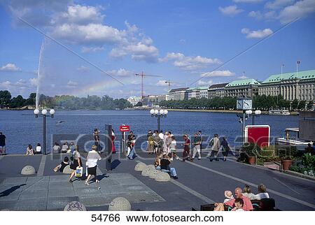 Tourists walking promenade at waterfront, Binnenalster, Hamburg, Germany View Large Photo Image Stock Photograph - Tourists walking promenade at waterfront, Binnenalster, Hamburg, Germany . Fotosearch