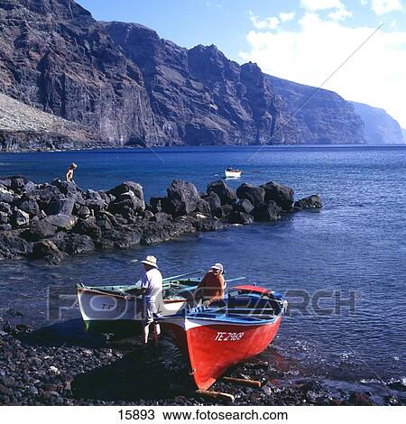 Stock Image - Tourists with canoes at coast, Los Gigante, Punta de Teno, Tenerife, Canary Islands, Spain . Fotosearch
