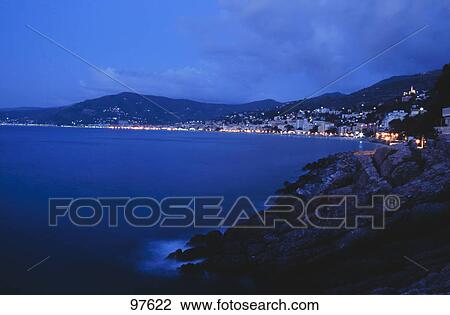 Town at the coast lit up at night,, Italian Riviera, Mar Ligure, Genoa, Liguria, Italy View Large Photo Image Stock Image - Town at the coast lit up at night,, Italian Riviera, Mar Ligure, Genoa, Liguria, Italy . Fotosearch