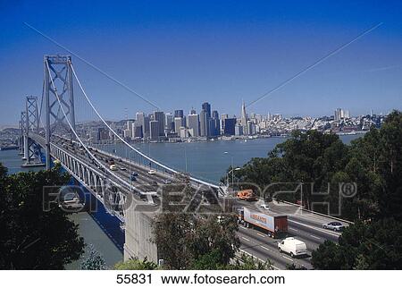 Stock Image - Traffic on bridge with city skyline in background, Oakland Bridge, San Francisco, California, USA . Fotosearch