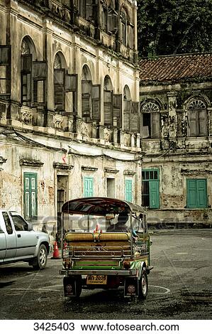 Tuk-tuk on a road between old buildings, Bangkok, Thailand View Large Photo Image Stock Image - Tuk-tuk on a road between old buildings, Bangkok, Thailand . Fotosearch