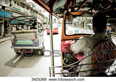Tuk-tuks on a street in Bangkok, Thailand View Large Photo Image Stock Photo - Tuk-tuks on a street in Bangkok, Thailand . Fotosearch