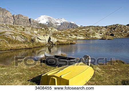 Stock Photography - Two boats on the lakefront, Canton Graubuenden, Switzerland . Fotosearch
