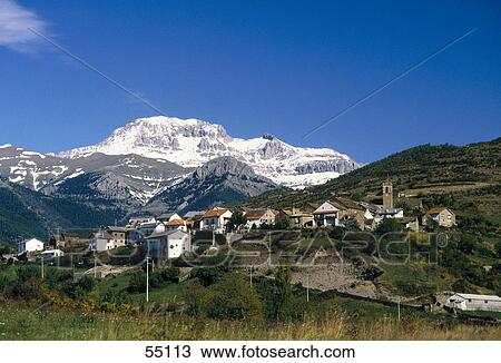Stock Image - Village with mountains in background, Jasa, Pyrenees, Huesca, Aragon, Spain . Fotosearch