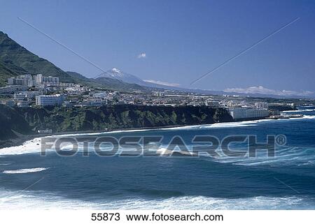 Waves in sea with city in background, Punta Del Hidalgo, Tenerife, Canary Islands, Spain View Large Photo Image Stock Image - Waves in sea with city in background, Punta Del Hidalgo, Tenerife, Canary Islands, Spain . Fotosearch