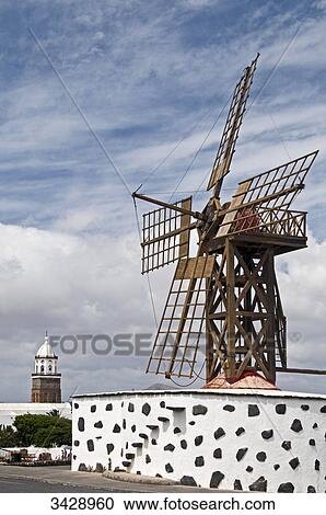 Windmill in Teguise, San Miguel Church in the background, Lanzarote, Spain, low angle view View Large Photo Image Stock Image - Windmill in Teguise, San Miguel Church in the background, Lanzarote, Spain, low angle view . Fotosearch