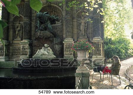 Stock Photo - Woman sitting in garden, Le Jardin Du Luxembourg, Paris, France . Fotosearch