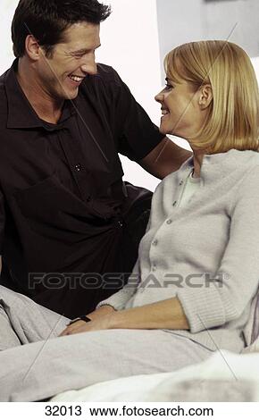Young couple looking at each other and smiling View Large Photo Image Stock Image - Young couple looking at each other and smiling . Fotosearch