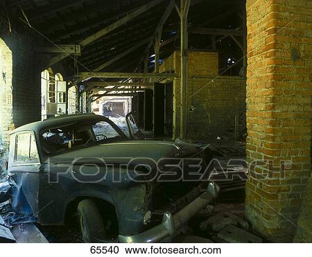 Stock Image - Abandoned car in factory storehouse . Fotosearch