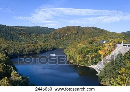Aerial view of boat in lake near dam, Rurtalsperre, Obersee, Eifel, North Rhine-Westphalia, Germany View Large Photo Image Stock Image - Aerial view of boat in lake near dam, Rurtalsperre, Obersee, Eifel, North Rhine-Westphalia, Germany . Fotosearch