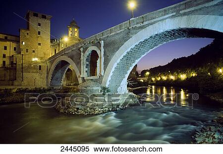 Stock Photography - Arch bridge over river at night, Pons Fabricius, Tiber River, Rome, Lazio, Italy . Fotosearch
