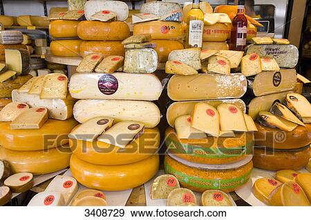 Stock Photo - Assortment of dutch cheese wheels and pieces, Amsterdam, Netherlands, elevated view . Fotosearch