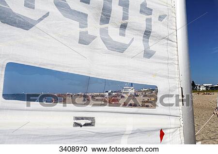 Beach of Warnemuende seen through a sail, Rostock, Germany View Large Photo Image Stock Image - Beach of Warnemuende seen through a sail, Rostock, Germany . Fotosearch