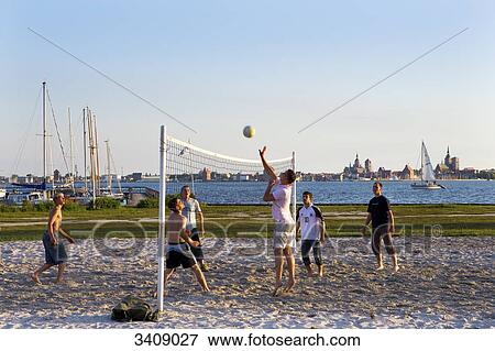 Stock Photo - Beachvolleyball player in Altefaehr, Stralsund in the background, Ruegen, Germany . Fotosearch