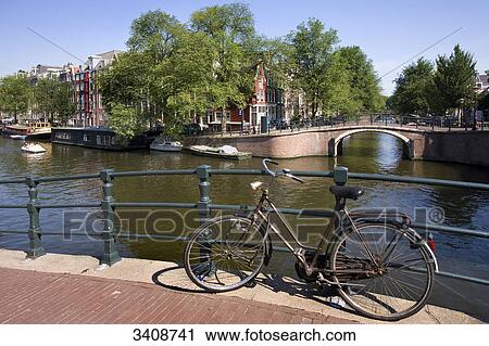 Bicycle on a bridge in Amsterdam, Netherlands View Large Photo Image Stock Image - Bicycle on a bridge in Amsterdam, Netherlands . Fotosearch