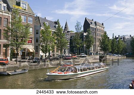 Stock Image - Boat in canal, Herengracht, Amsterdam, Netherlands . Fotosearch