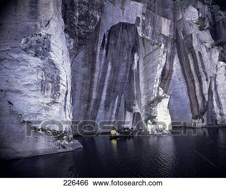 Stock Photograph - Boat near rock formations, China . Fotosearch