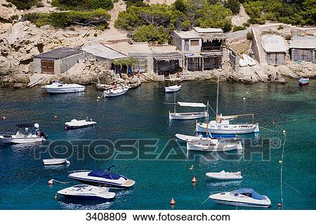 Boats and boat houses at the bay of Cala Vadella, Ibiza, Spain, elevated view View Large Photo Image Stock Photo - Boats and boat houses at the bay of Cala Vadella, Ibiza, Spain, elevated view . Fotosearch