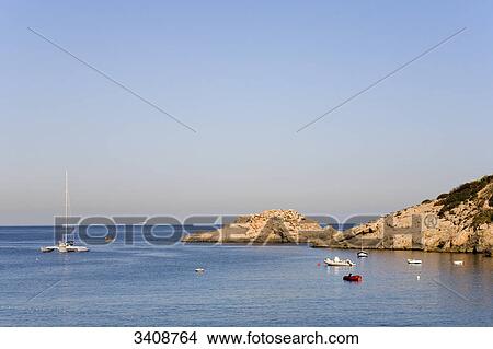 Picture - Boats at the rocky coast of Cala d Hort, Ibiza, Spain, elevated view . Fotosearch