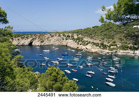 Stock Image - Boats in sea, Cala Vadella, Ibiza, Balearic Islands, Spain . Fotosearch