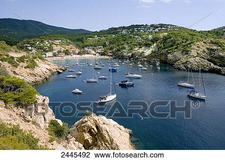 Stock Image - Boats in sea, Cala Vadella, Ibiza, Balearic Islands, Spain . Fotosearch