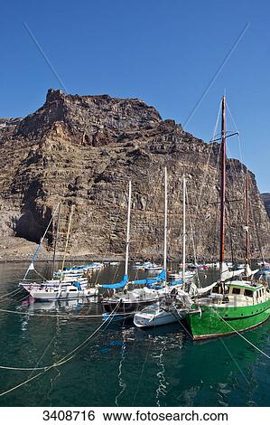 Stock Photograph - Boats in the harbour of Valle Gran Rey, La Gomera, Spain . Fotosearch