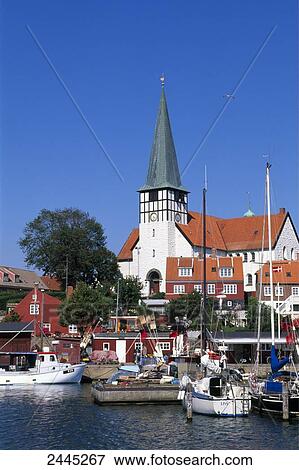 Stock Photo - Boats on harbor with church in background, Ronne, Bornholm, Denmark . Fotosearch