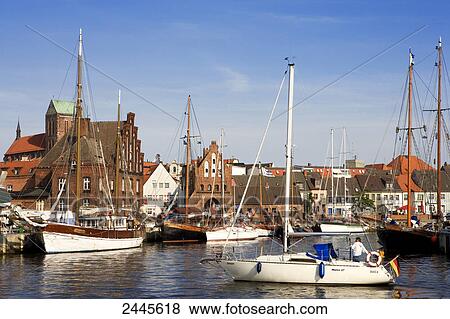 Stock Photo - Boats on harbor with church in background, Wismar, Mecklenburg-West Pomerania, Germany . Fotosearch