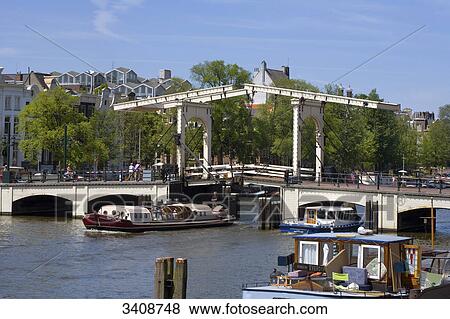 Boats on the Amstel River, Amsterdam, Netherlands View Large Photo Image Stock Photo - Boats on the Amstel River, Amsterdam, Netherlands . Fotosearch