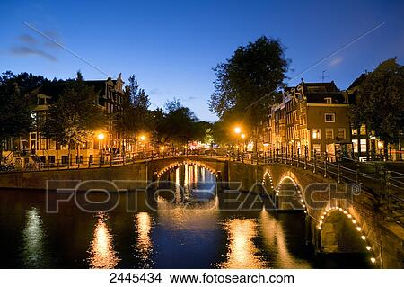 Picture - Bridge across canal lit up at night, Keizersgracht, Amsterdam, Netherlands . Fotosearch