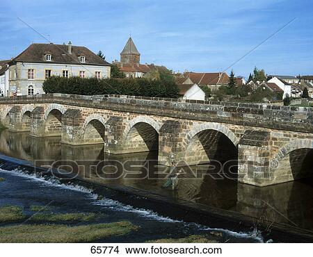 Bridge across river in town, Burgundy, France View Large Photo Image Picture - Bridge across river in town, Burgundy, France . Fotosearch
