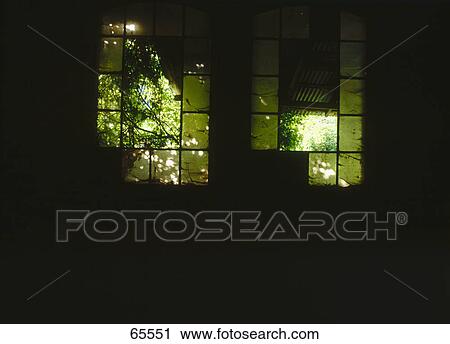 Stock Image - Broken green glasses of window of abandoned room . Fotosearch