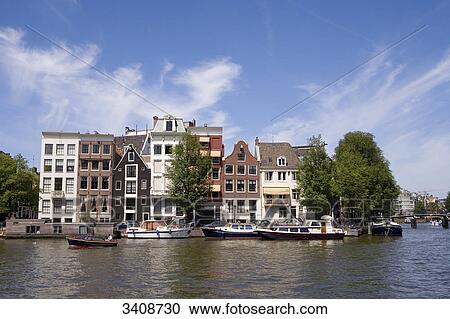 Buildings at the waterfront of the Amstel River, Amsterdam, Netherlands View Large Photo Image Stock Image - Buildings at the waterfront of the Amstel River, Amsterdam, Netherlands . Fotosearch