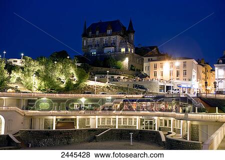 Stock Photo - Buildings in city lit up at night, Port Vieux, Biarritz, Pyrenees-Atlantiques, Aquitaine, France . Fotosearch