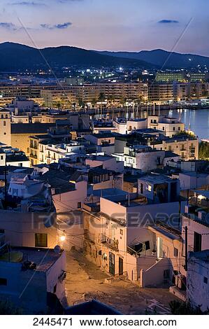 Stock Image - Buildings in town lit up at night, Dalt Vila, Ibiza, Balearic Islands, Spain . Fotosearch