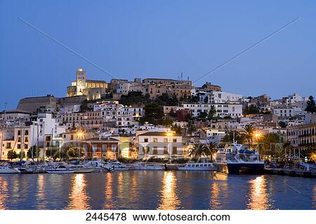 Buildings in town lit up at night, Dalt Vila, Ibiza, Balearic Islands, Spain View Large Photo Image Stock Photo - Buildings in town lit up at night, Dalt Vila, Ibiza, Balearic Islands, Spain . Fotosearch