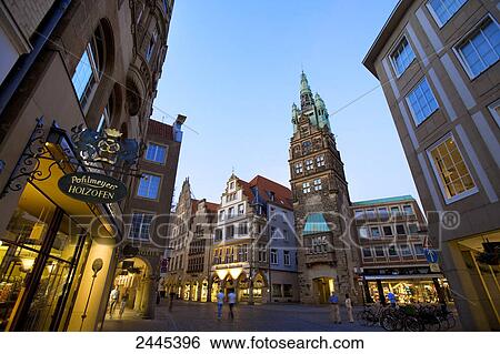 Stock Photograph - Buildings lit up at dusk in city, Prinzipialmarkt, Stadtturm, Muenster, North Rhine-Westphalia, Germany . Fotosearch